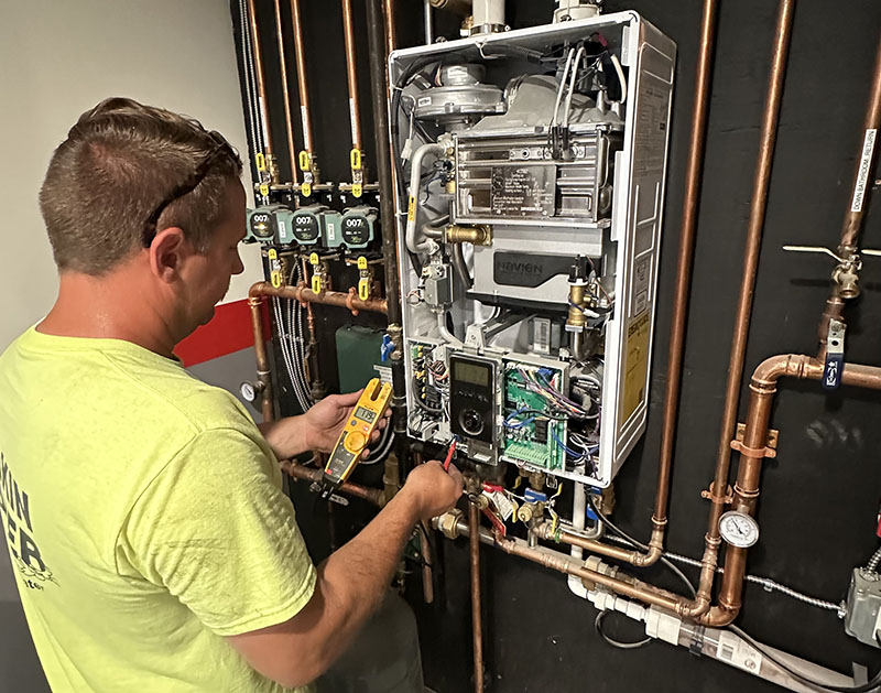 Technician troubleshooting emergency heating service